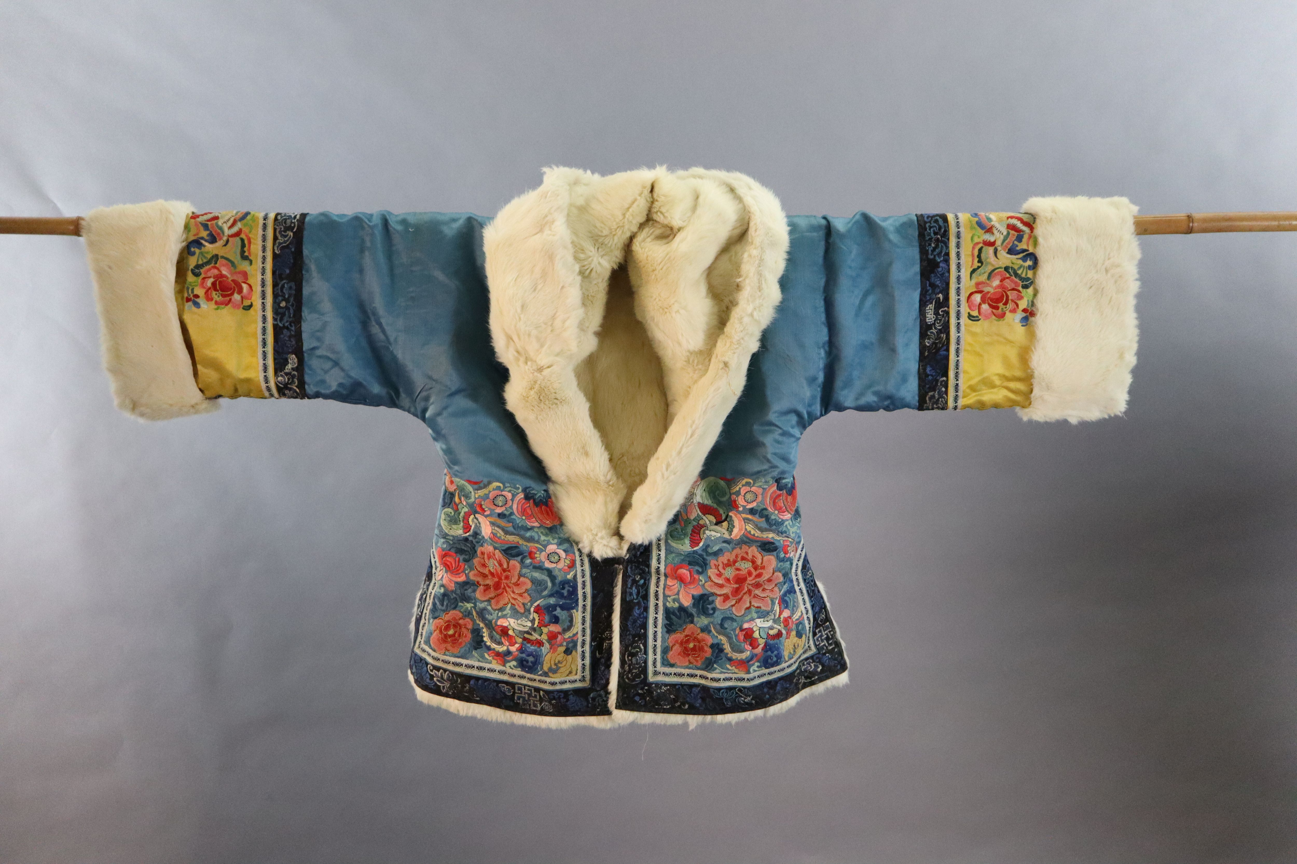 A Chinese embroidered silk winter jacket, late 19th/early 20th century, length 70cm